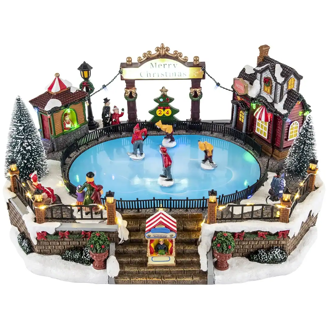 Ледена пързалка с коледна украса, светлини и миниатюрни туристически атракции, идеална за коледни партита и забавления за деца и семейства.